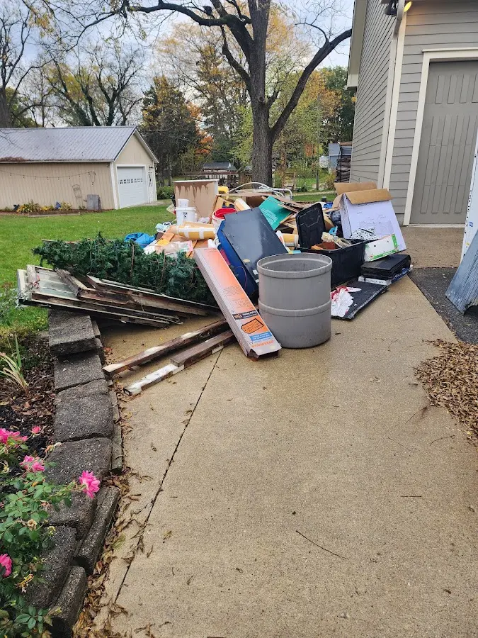 Dumpster being loaded with debris for Roofing Dumpster Rental in Jennings